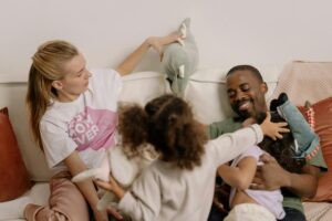 Happy interracial family spending quality time together in a cozy living room setting.